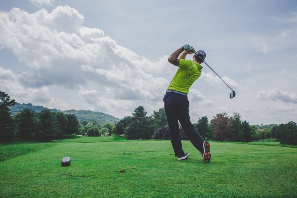 Man swinging a golf club in Asheville, North Carolina.
