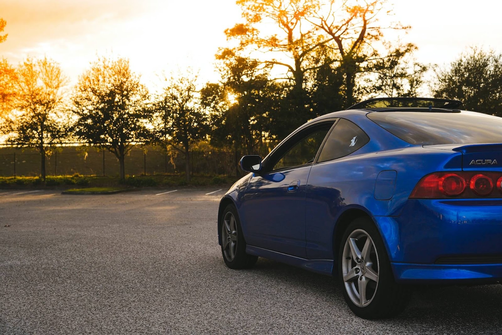 Blue Acura looks at the sunset.