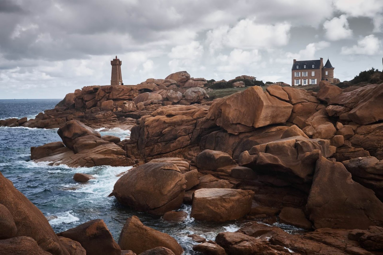 The Ploumanac'h Lighthouse in Perros-Guirec, France, on an overcast day.