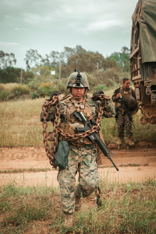 Marine with rifle outdoors.