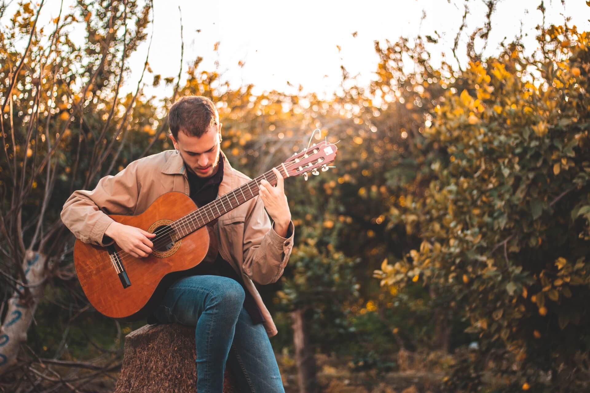 A man holding and strumming a guitar