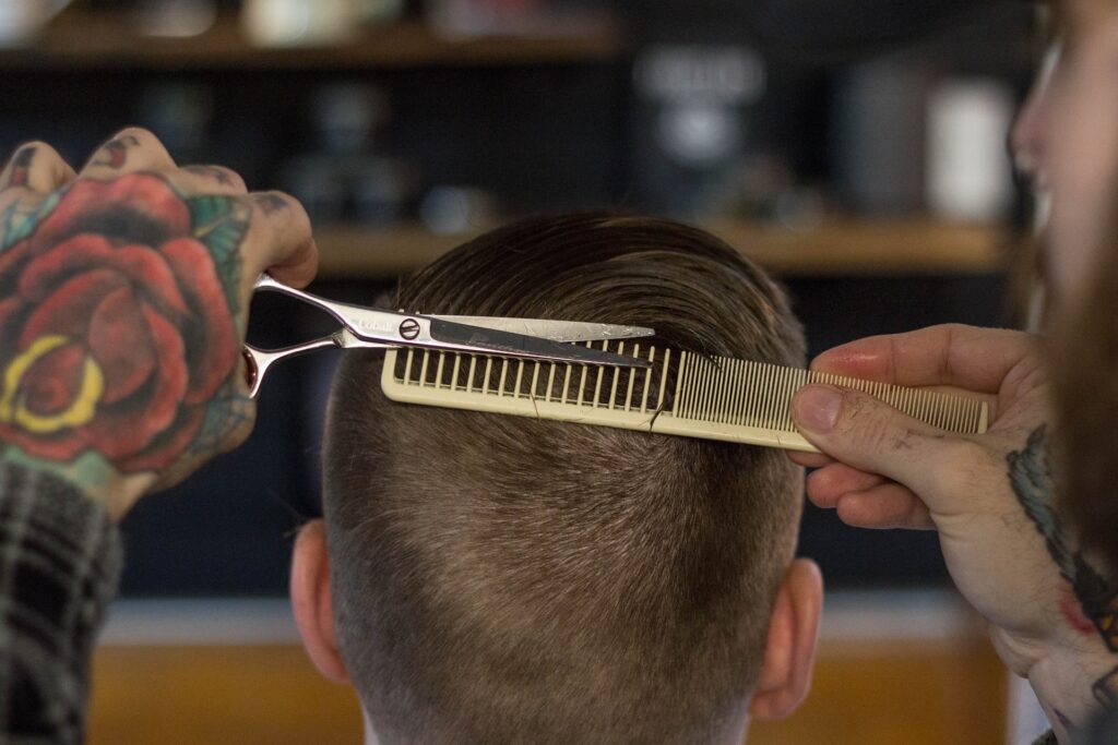 A barber cutting a customer's hair