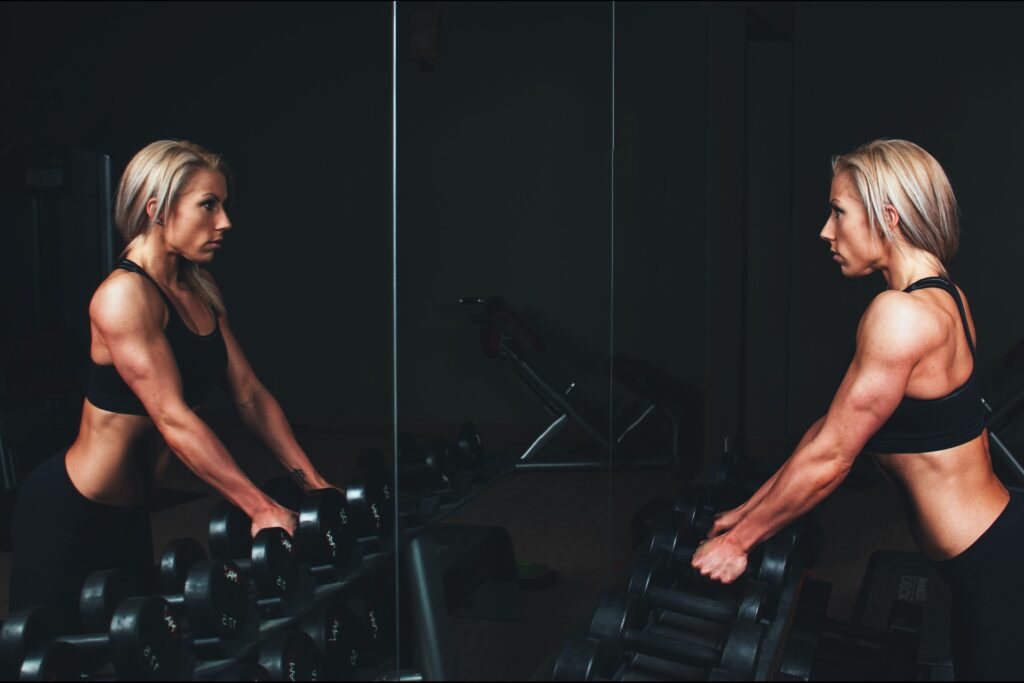 Woman looking into gym mirror