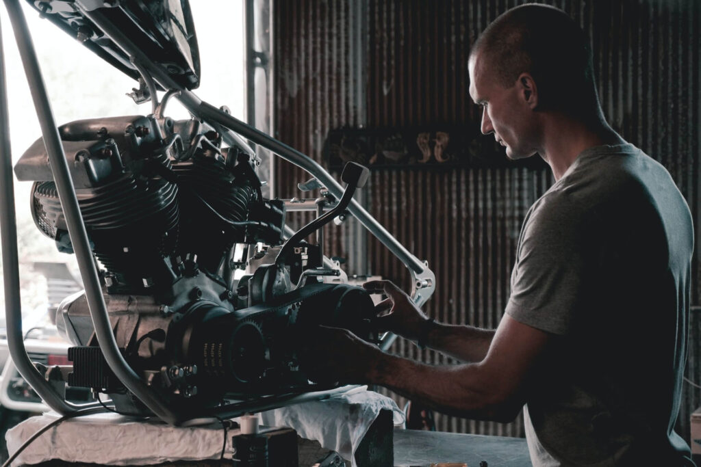 A mechanic working on a removed alternator