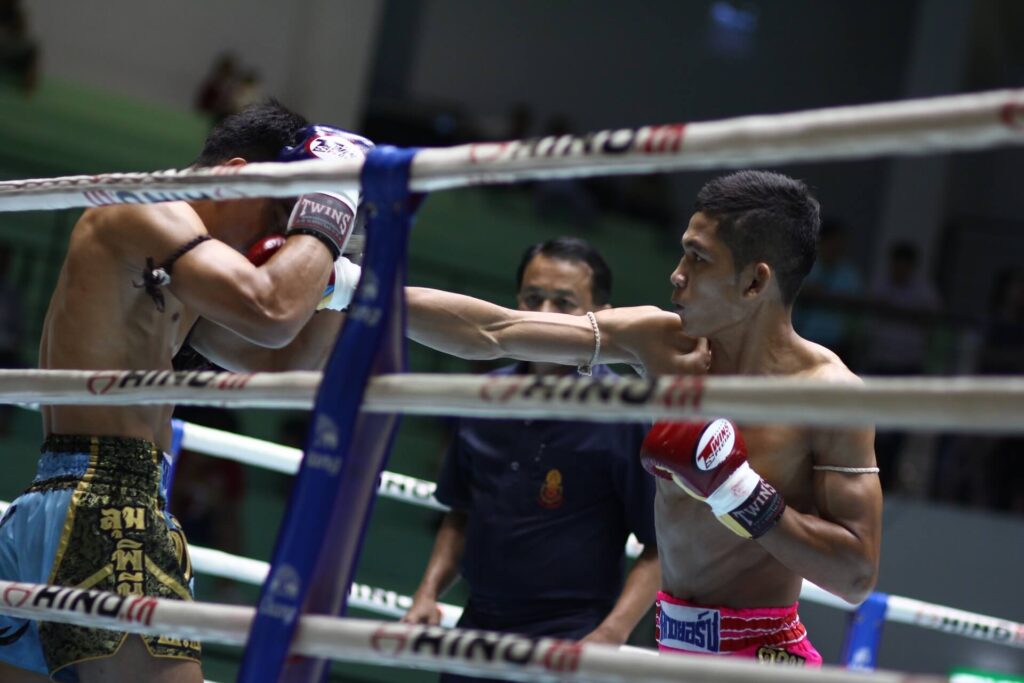 Muay Thai fighter punching his opponent in defense
