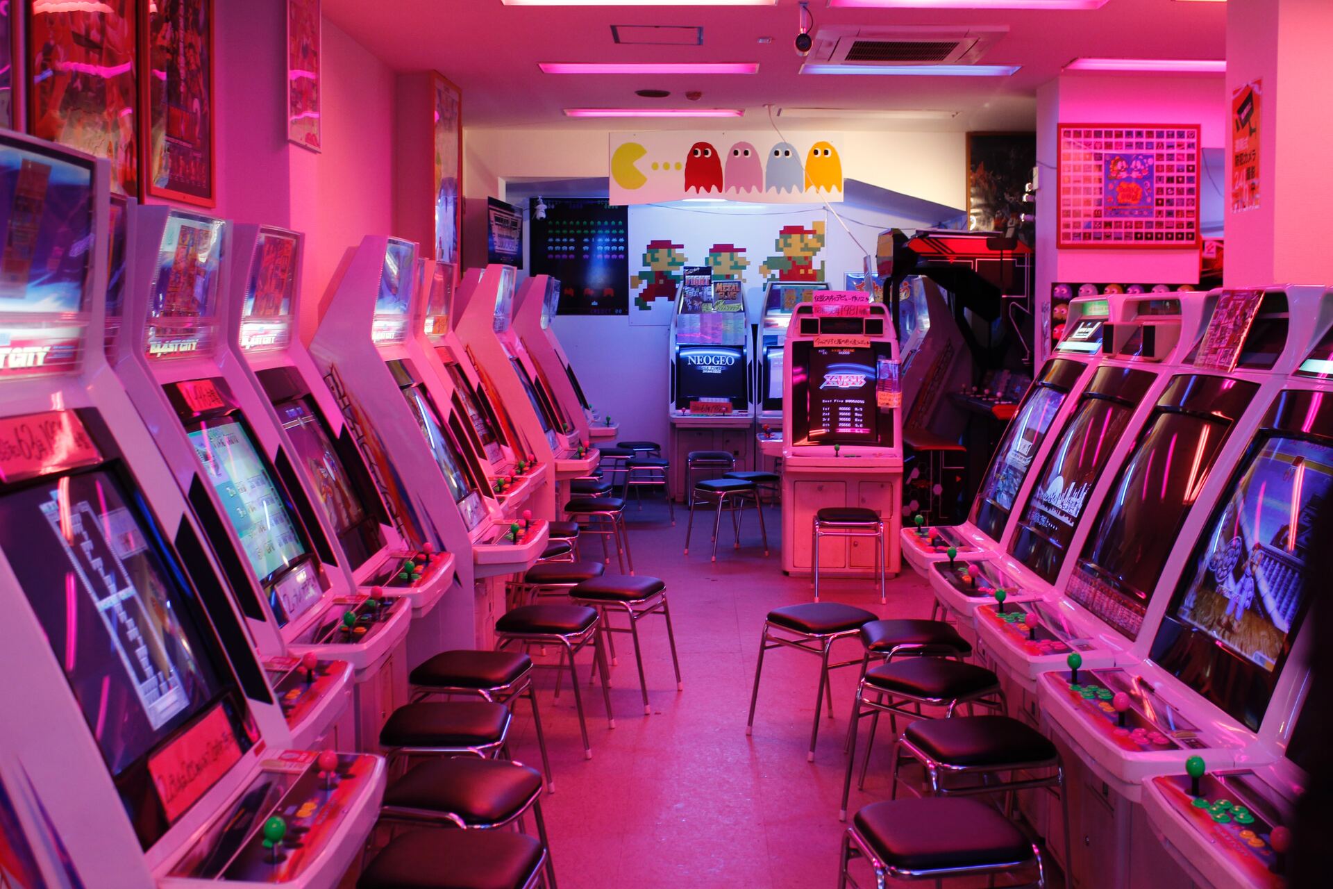An arcade with many video game machines standing around