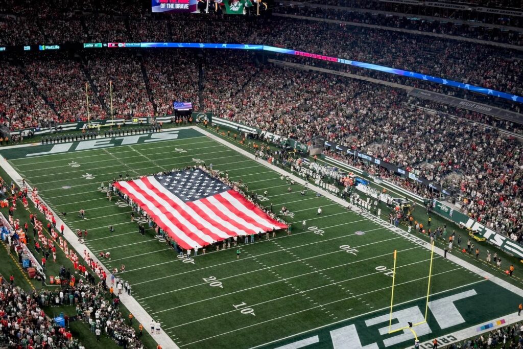 An American flag carried on a Jets field
