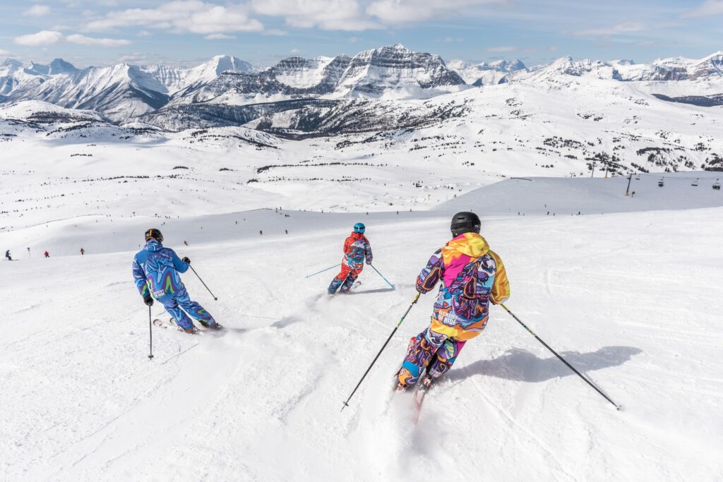 Three people skiing down a mountain