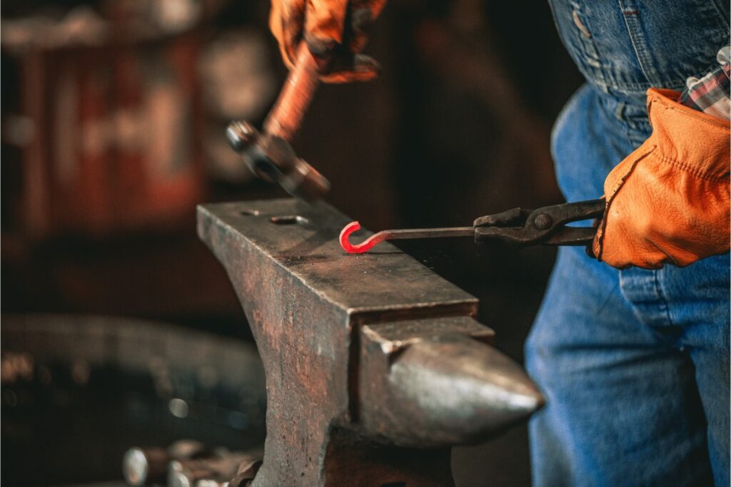 A blacksmith creating a hook.