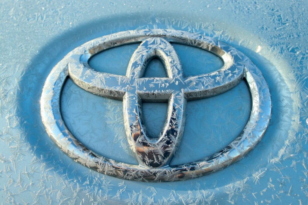 Toyota logo on a car iced over.