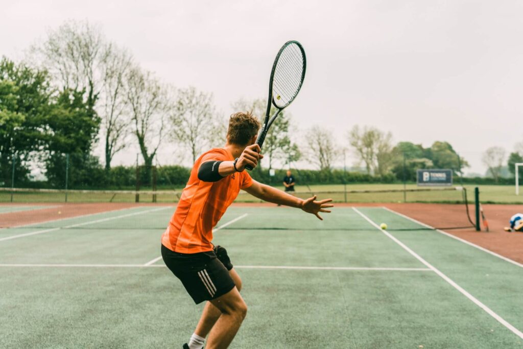 Two people playing tennis in the United Kingdom.