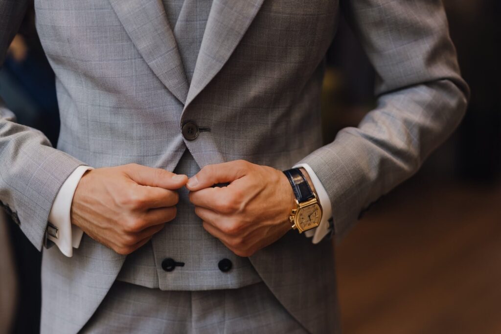 man wearing grey blazer with four-holed sew-through button