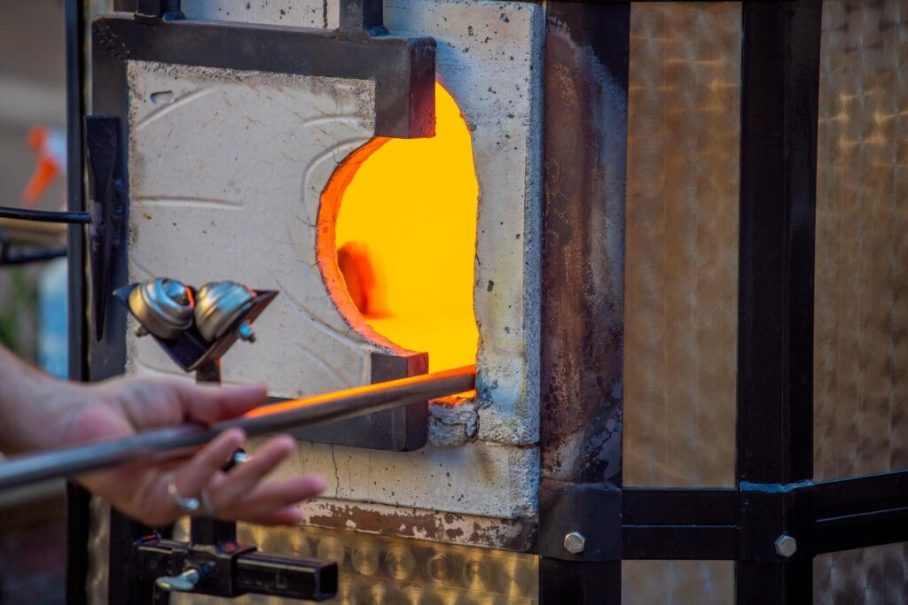 A blacksmith smelting metal in the forge.