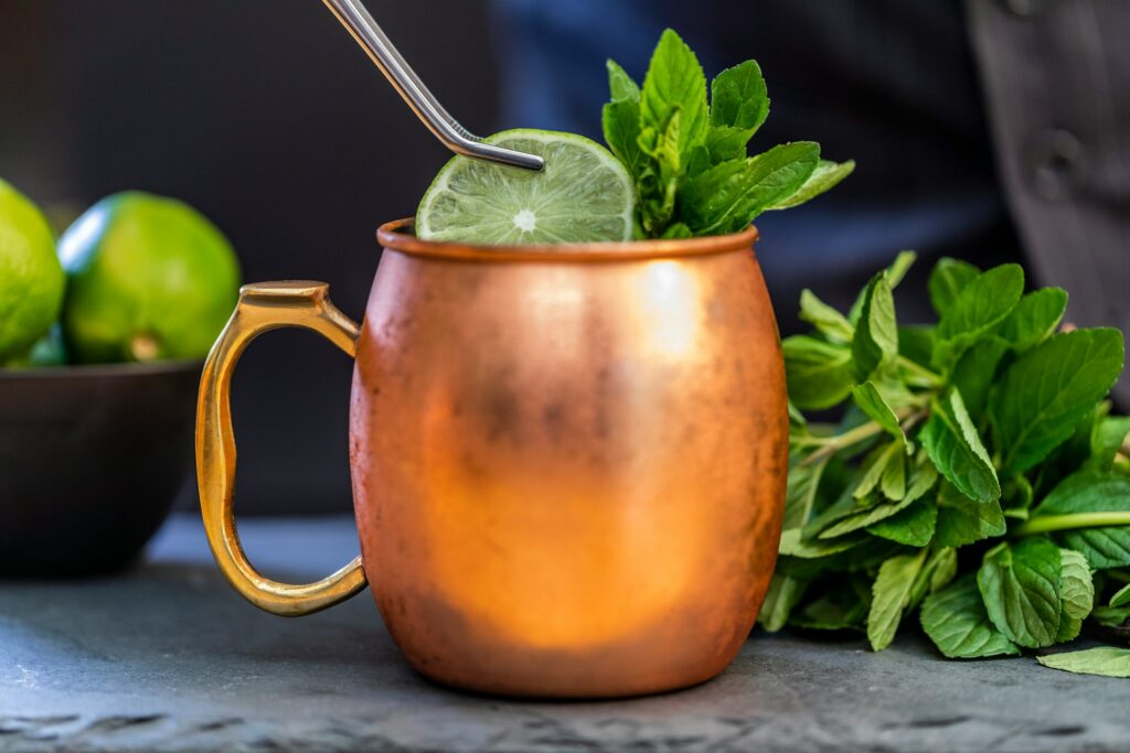 a mint julep in a brass mug