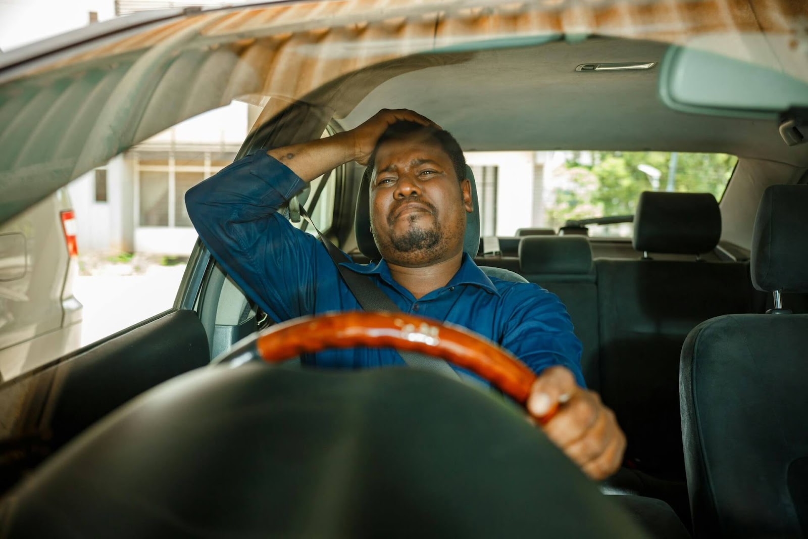 Man with worried expression in a car.