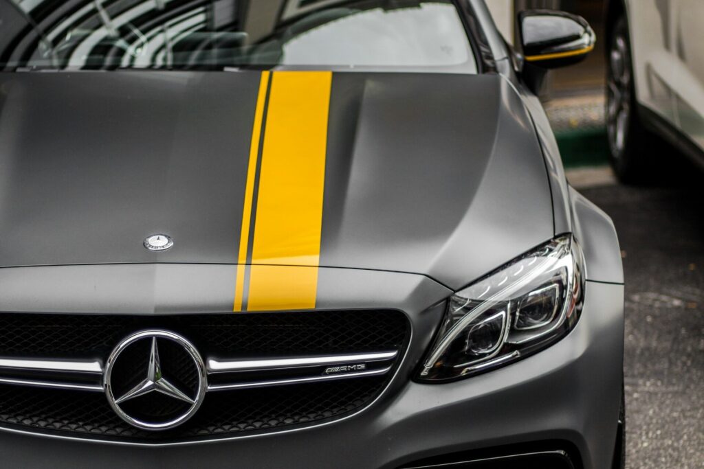Yellow racing stripes painted on silver Mercedes