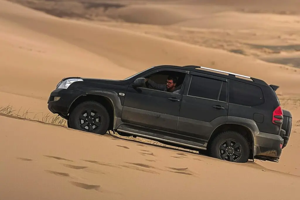 suv in in the sand.