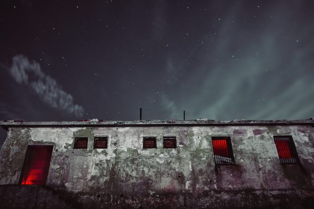 abandoned building with red lights and a clear sky. 