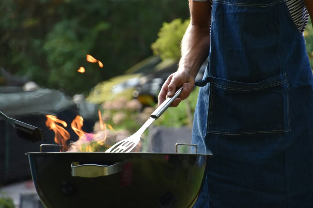 Man in an apron grilling