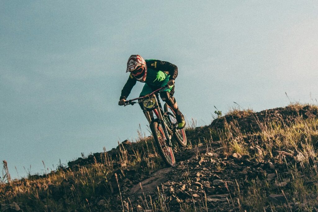 Helmeted biker speeding down a mountain