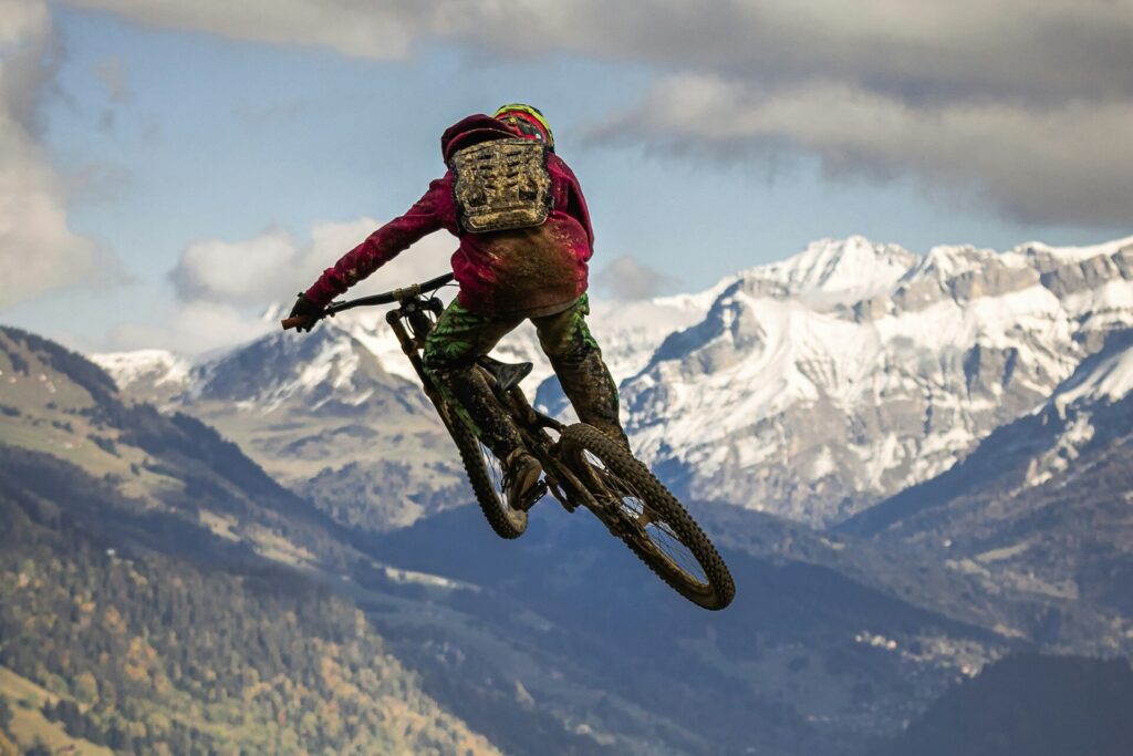 Mountain biker ramping off of a mountain top