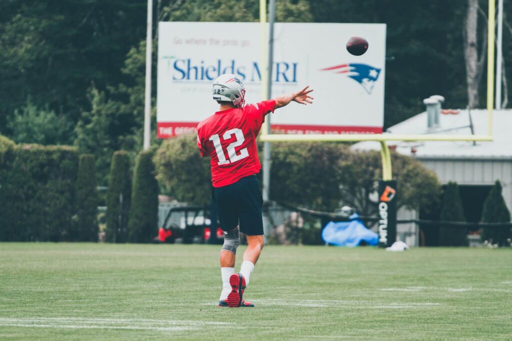 Tom Brady throwing a football at practice. 