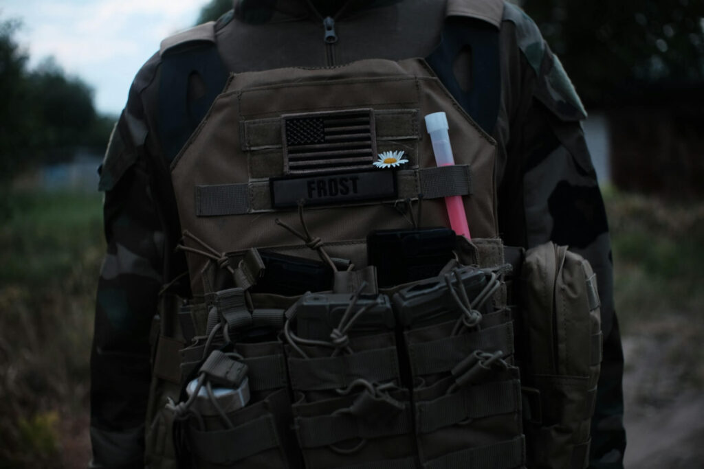 Person carries a black and gray military backpack