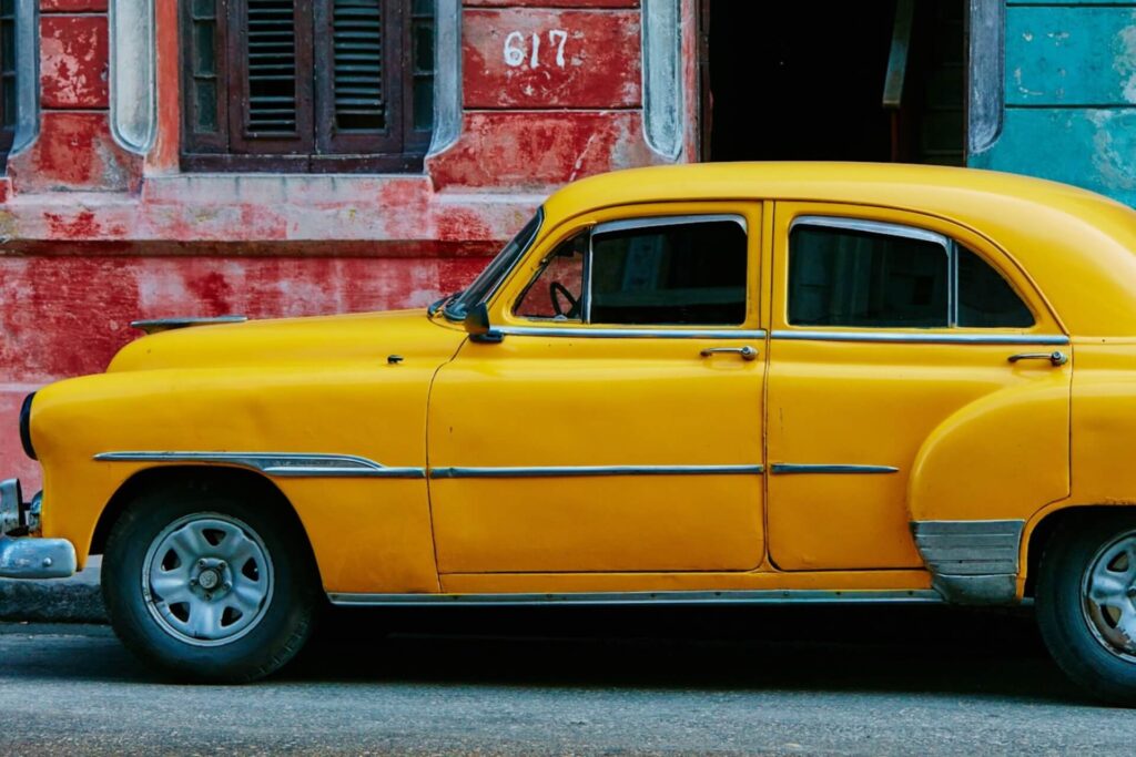 Yellow car parked beside a building