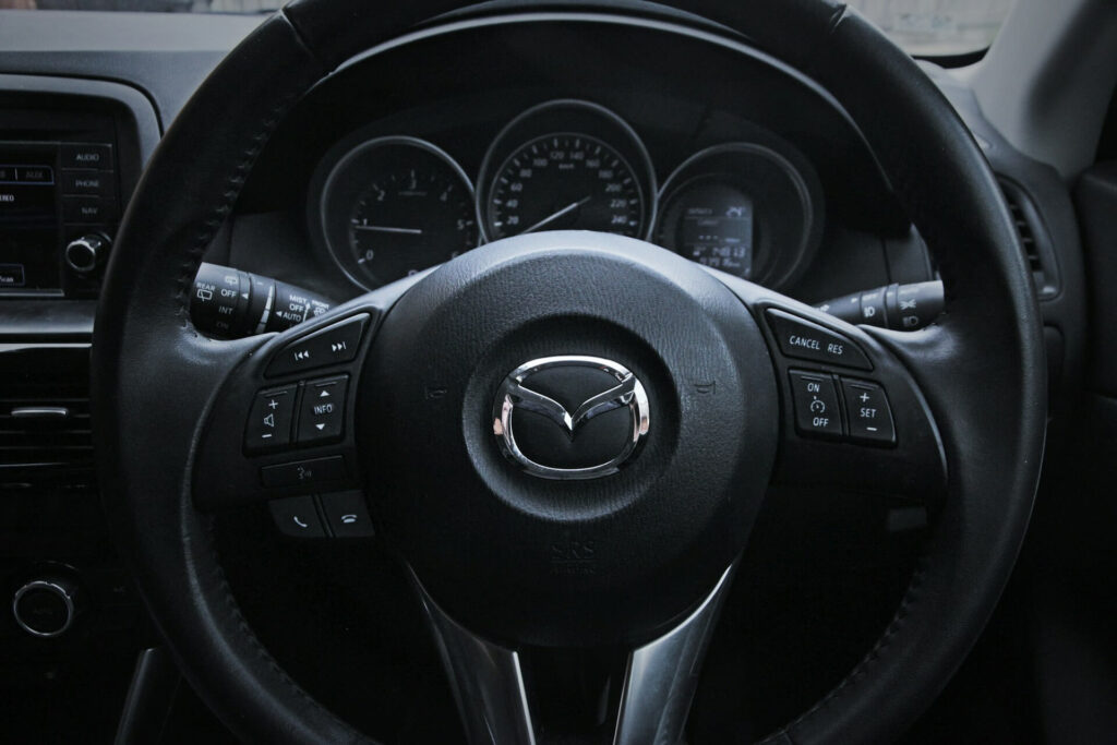 Steering wheel and dashboard inside a Mazda