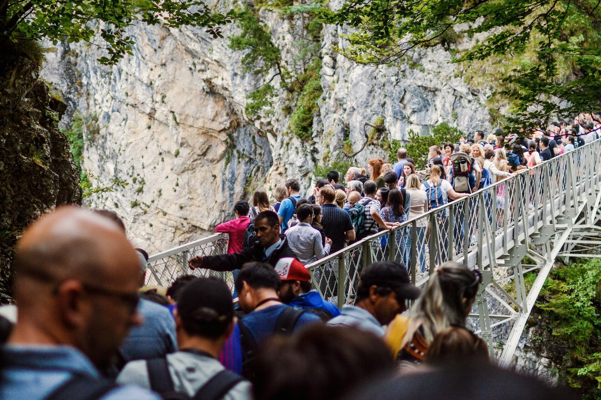 An overcrowded metal mountain bridge