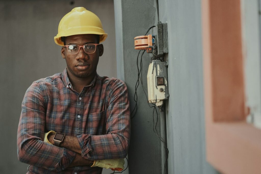 Man with plaid shirt and construction hat on