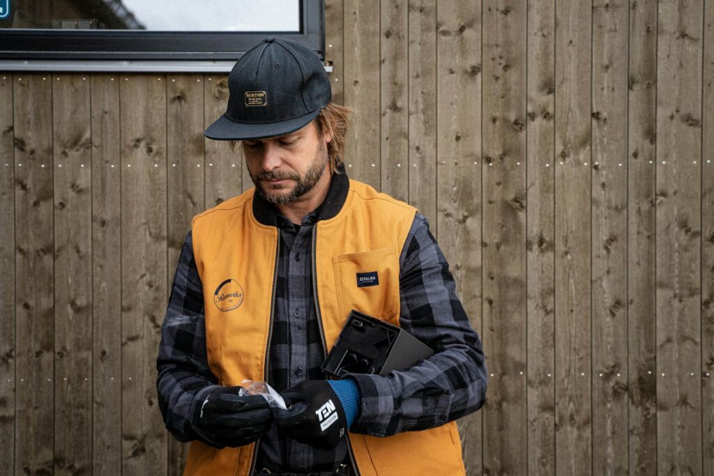 Electrician with work gloves working with an electrical box