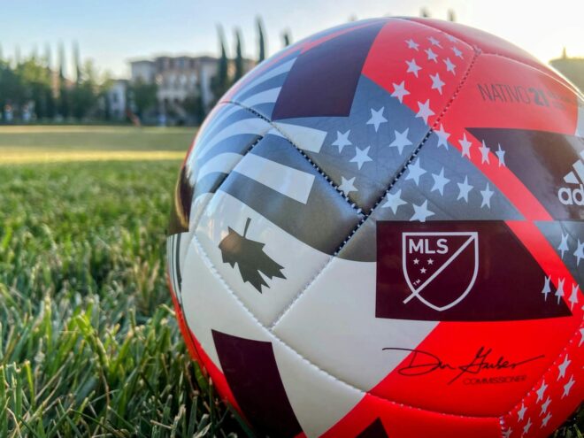 A Canadian-themed soccer ball on a green field