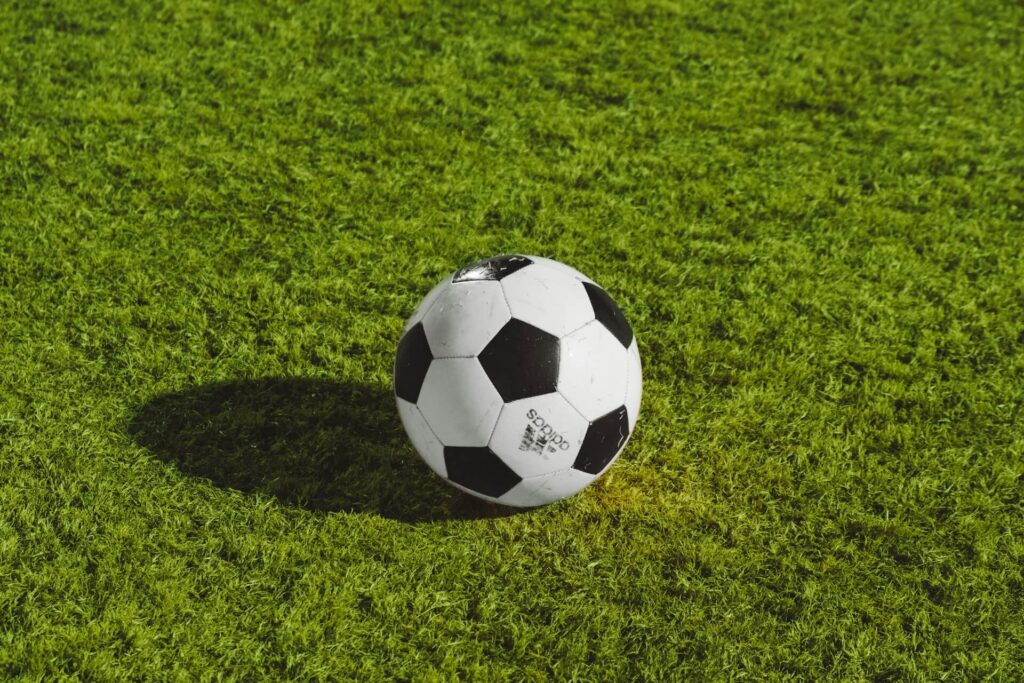 A black-and-white soccer ball on a green field