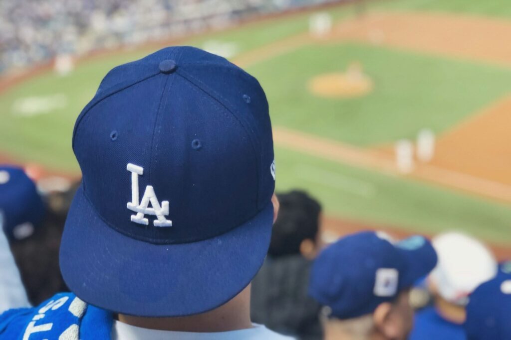 Man wears a Los Angeles Dodgers hat at Dodger Stadium