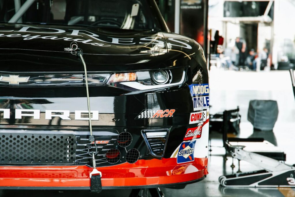 Black and red Chevrolet stock car in the garage at Texas Motor Speedway