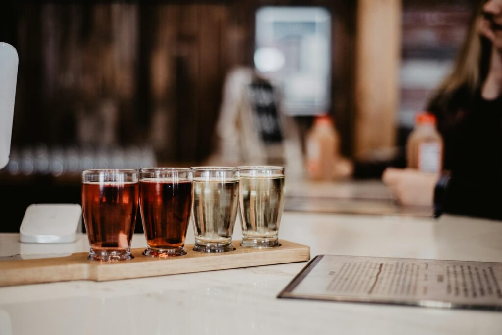 Four glasses of cider on a restaurant table