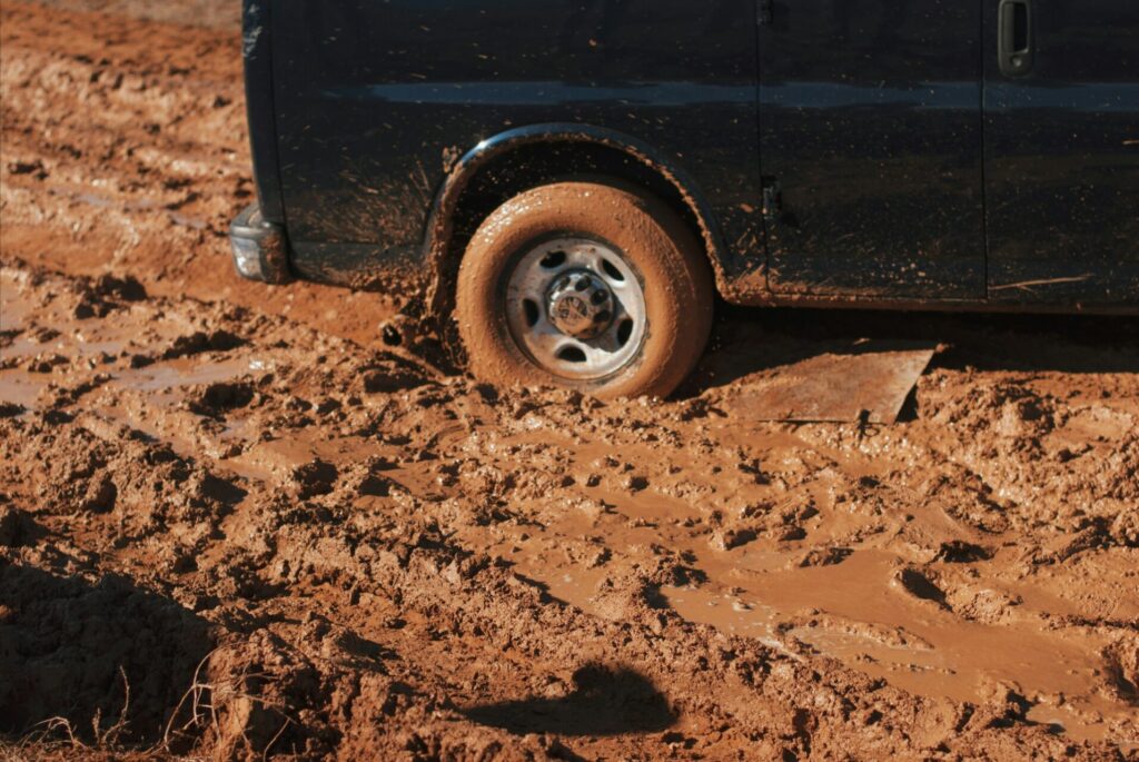 black van stuck in the mud