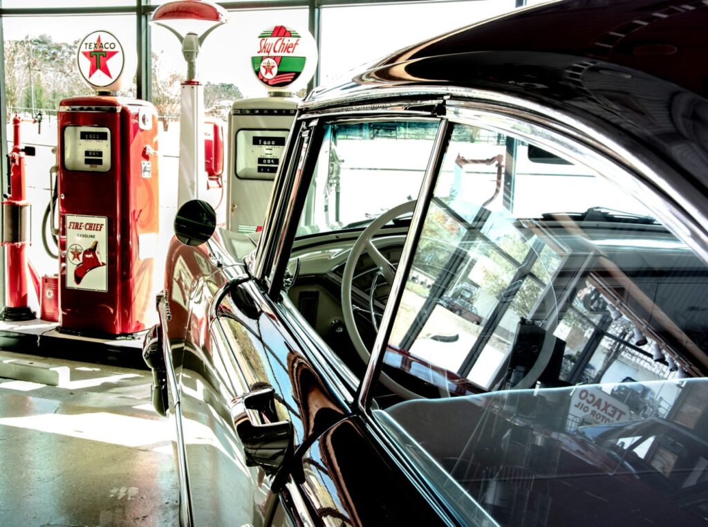 A vintage car at a gas station