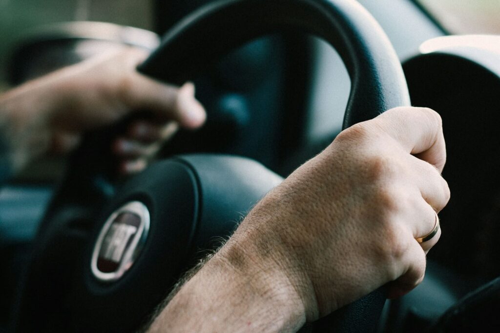 Hands gripping a steering wheel