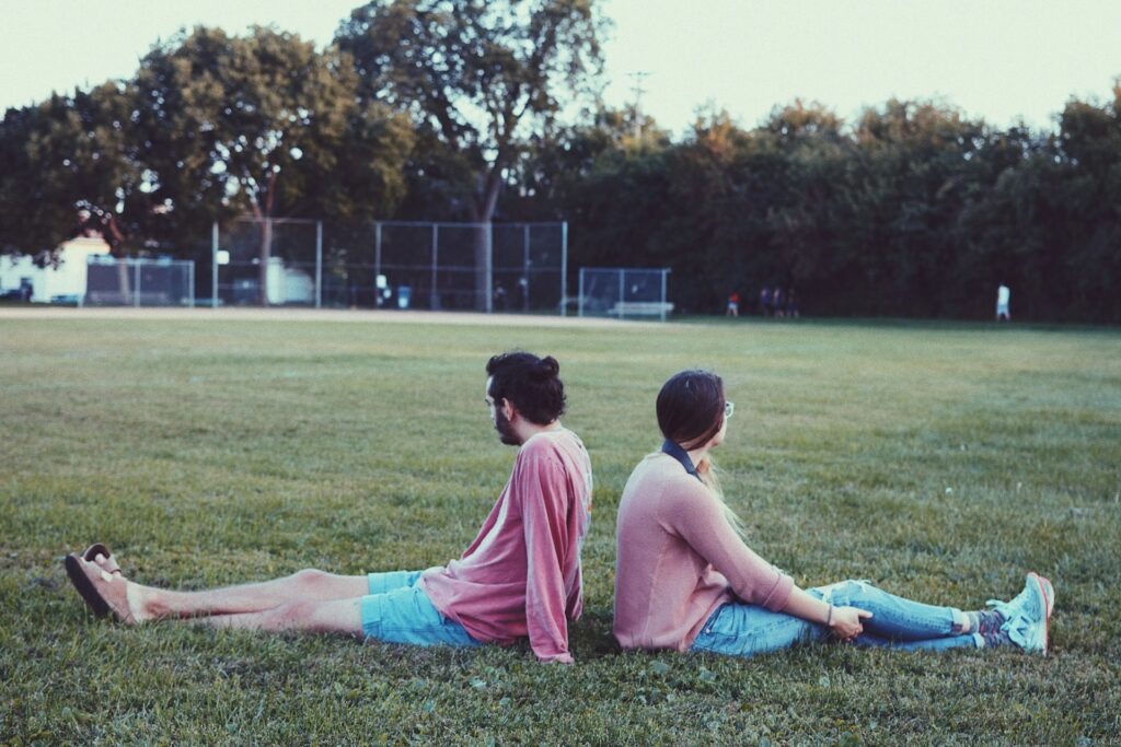 a man and woman in matching pink and blue outfits