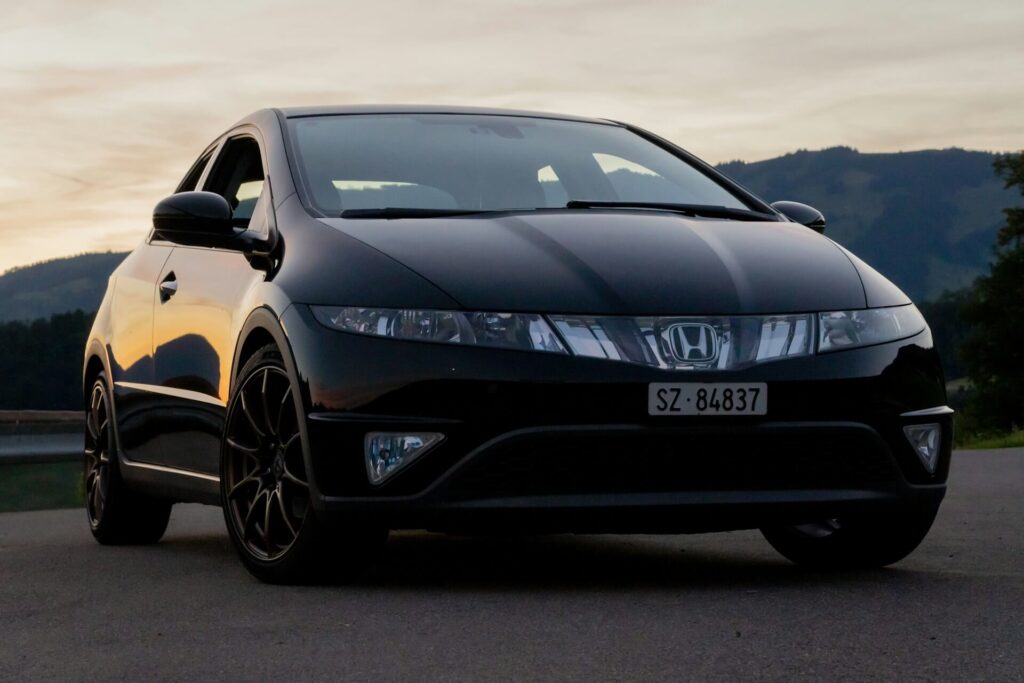 A black Honda Civic parked on pavement